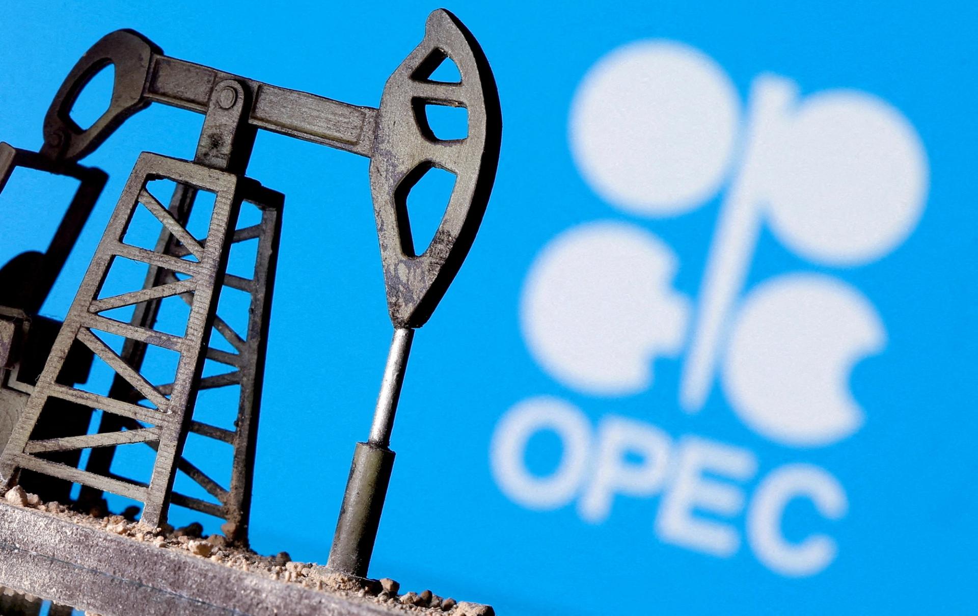 A 3D printed oil pump jack is seen in front of displayed OPEC logo in this illustration picture