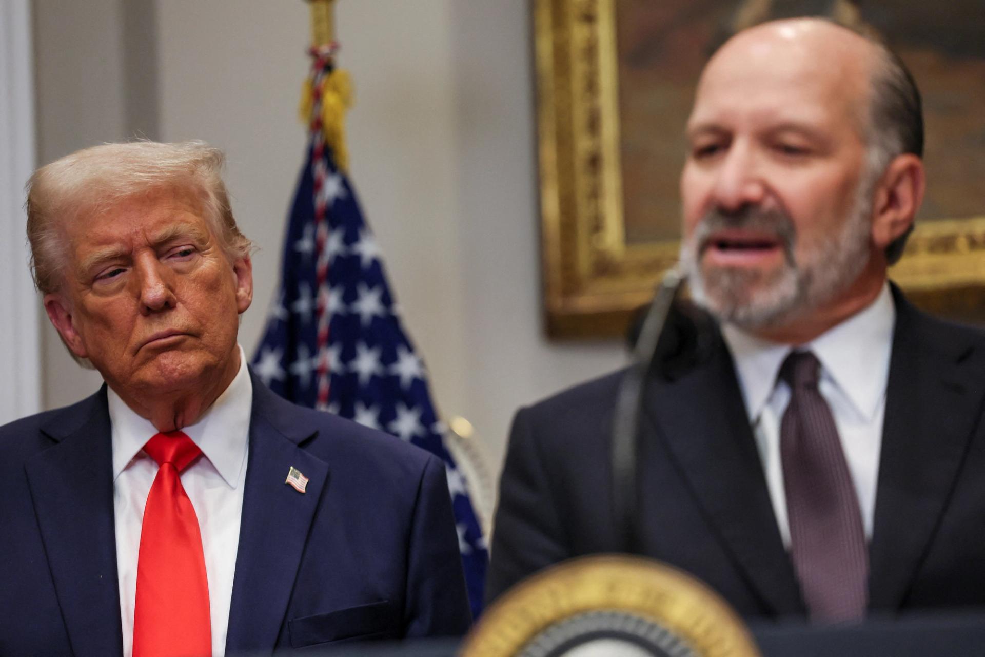 Howard Lutnick speaks next to Donald Trump in the Roosevelt Room of the White House.