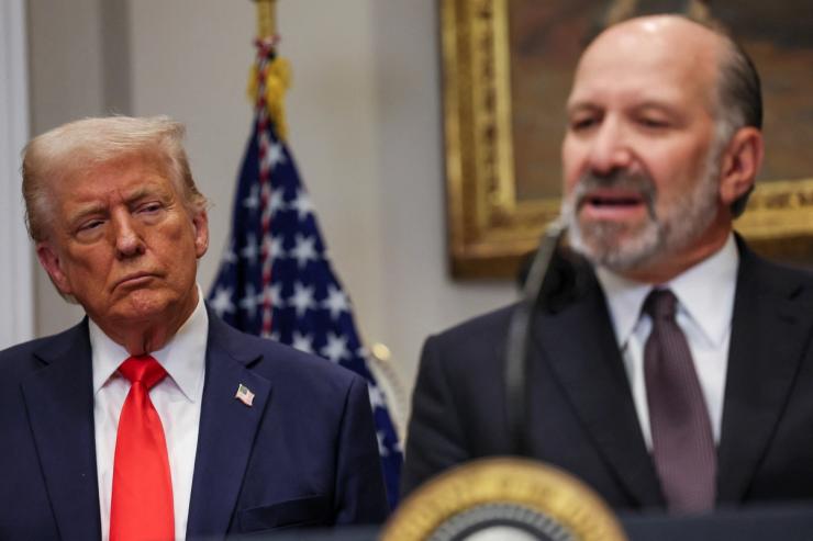 Howard Lutnick speaks next to Donald Trump in the Roosevelt Room of the White House.