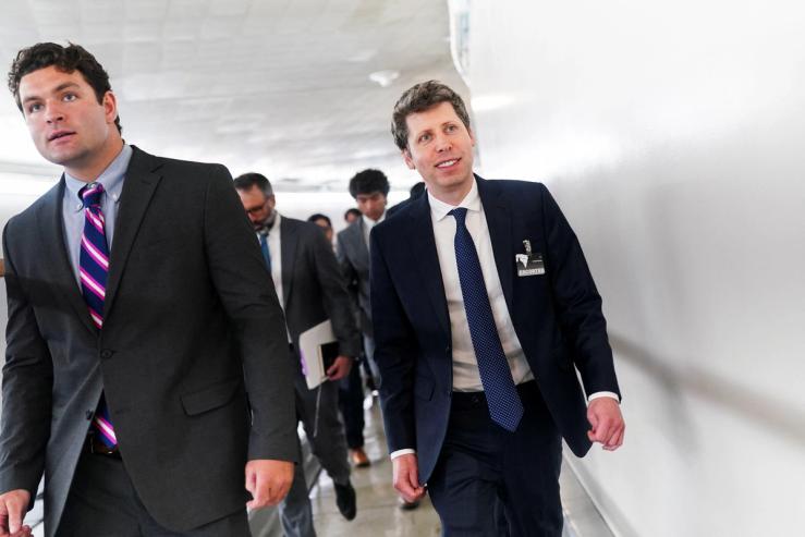 OpenAI CEO Sam Altman walks between meetings on Capitol Hill.