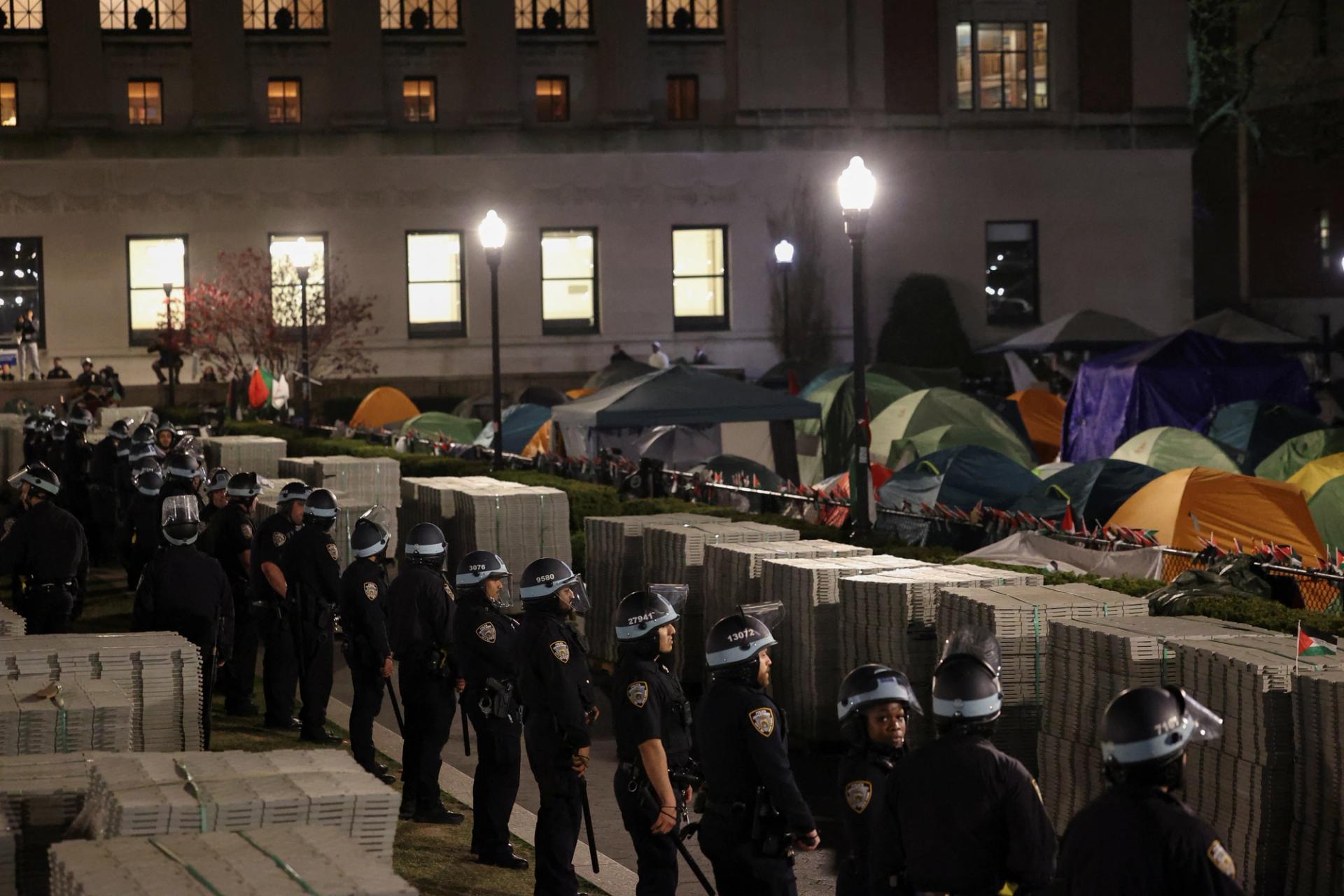 Police stand guard near an encampment of protesters supporting Palestinians on the grounds of Columbia University on April 30, 2024.