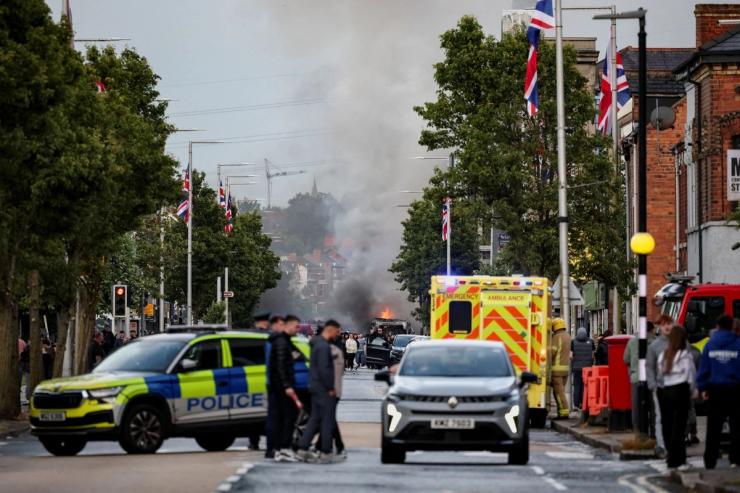Fires burn in Belfast with emergency responders nearby