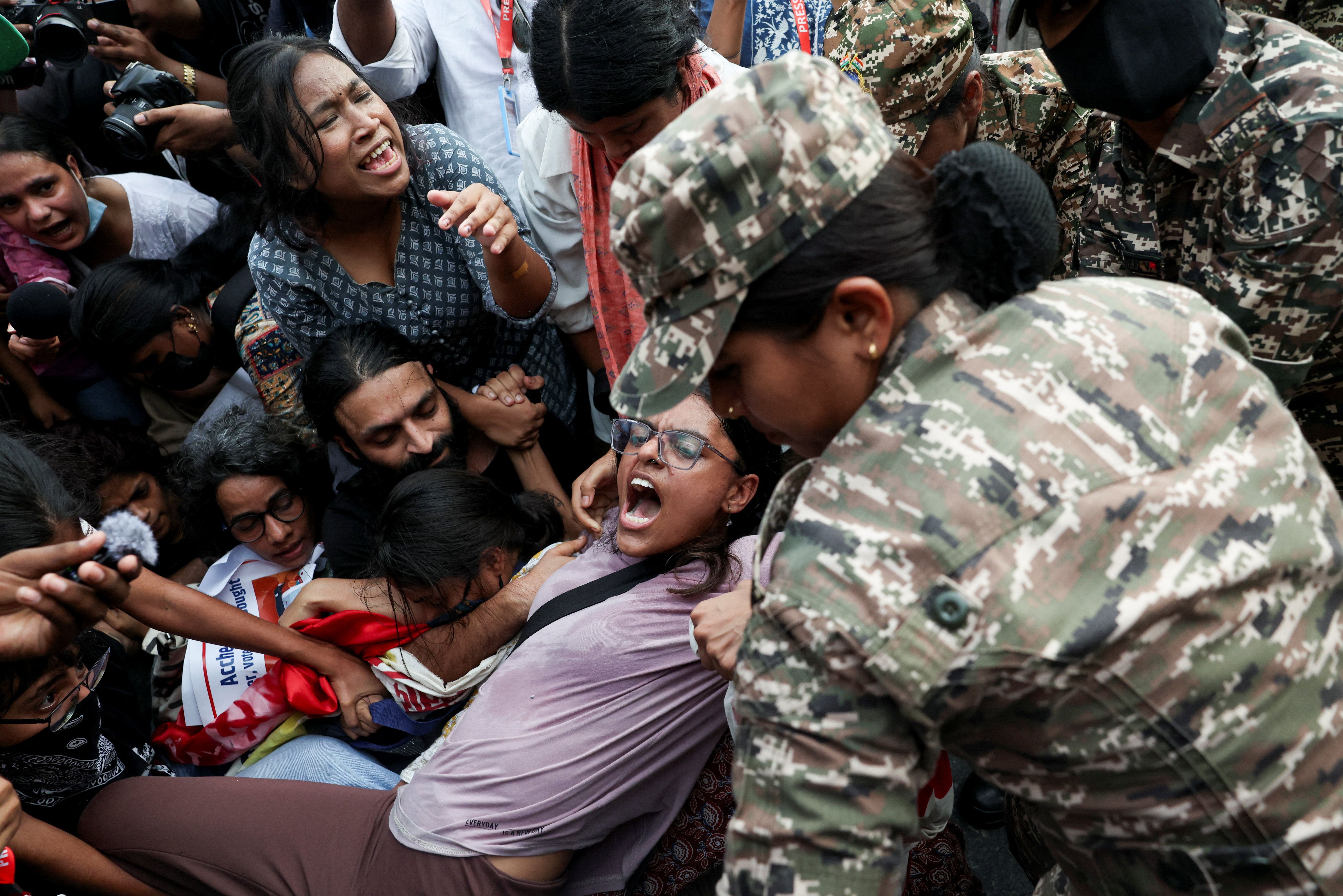 Protesters react as they are detained by security personnel during a protest seeking the resignation of India’s Chief Election Commissioner Gyanesh Kumar