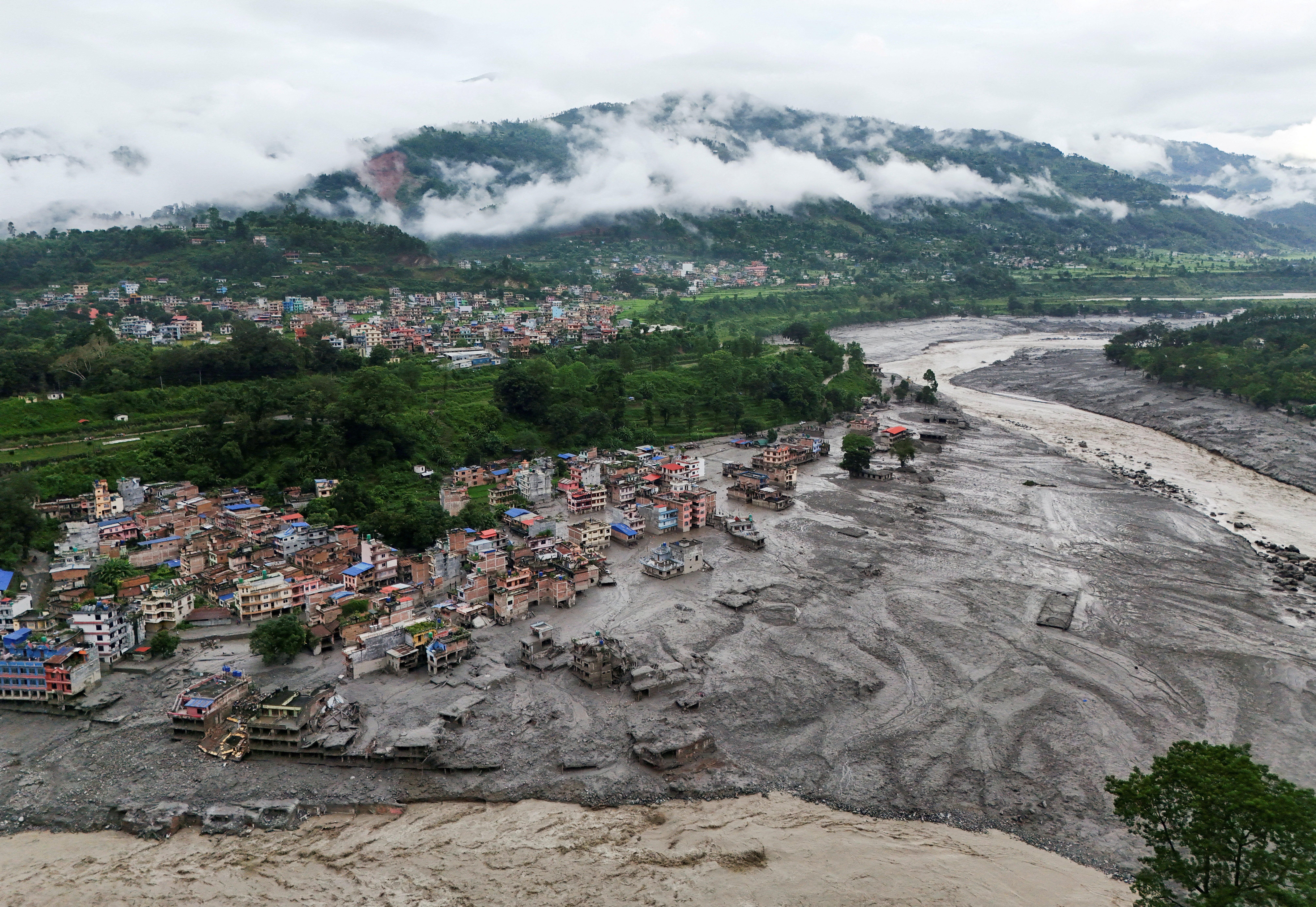 A drone view shows mud covering properties following a flash flood in Trishuli, Nuwakot district, Nepal