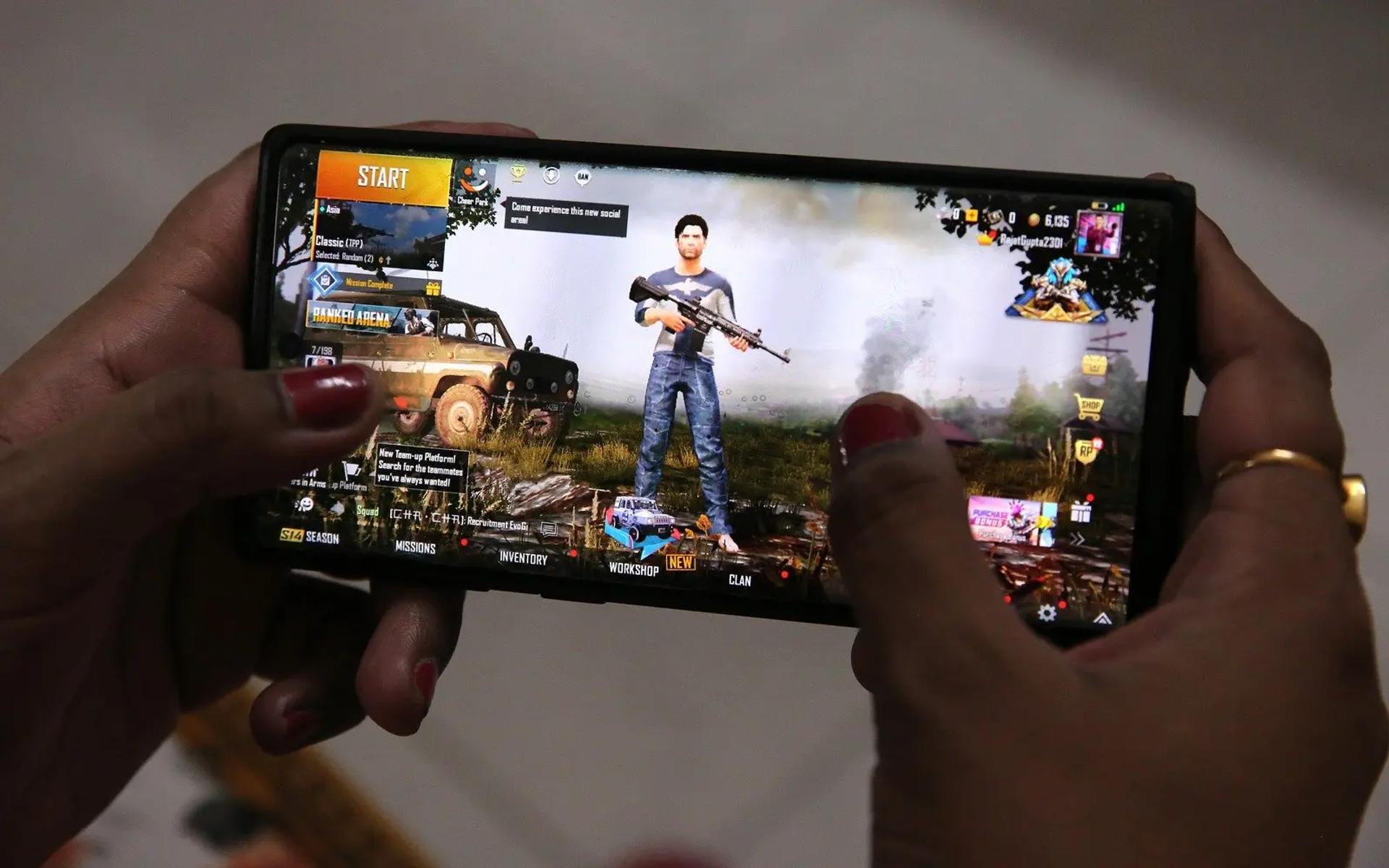 Gamer playing PUBG Mobile on a phone.  