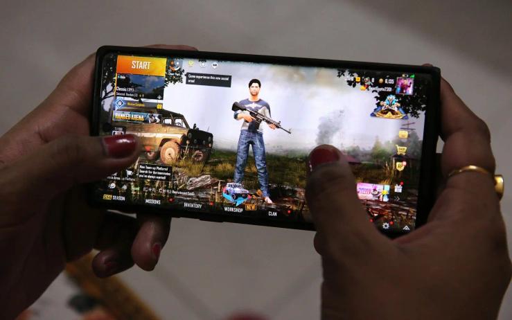 Gamer playing PUBG Mobile on a phone.