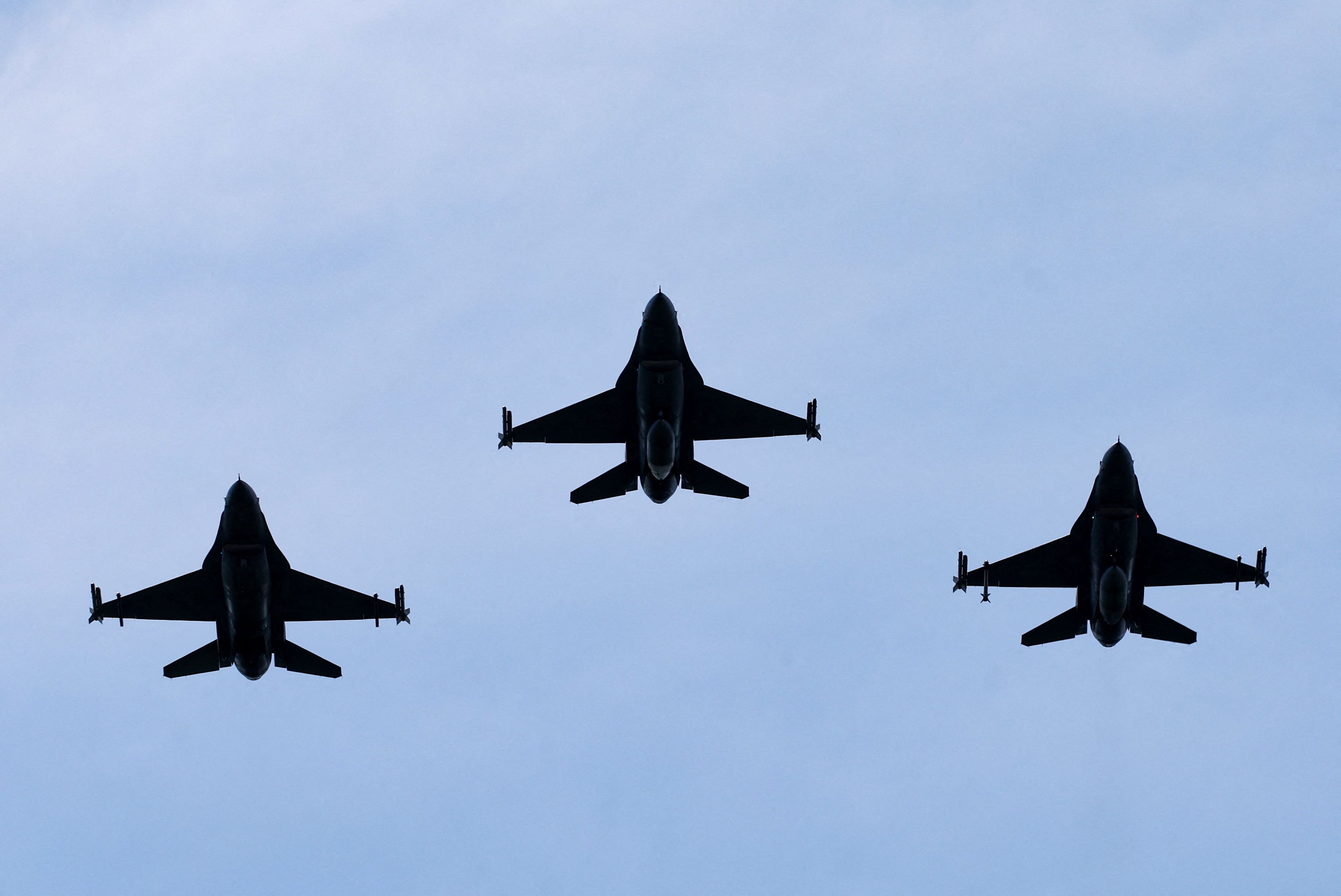 Belgian F-16 jets fly during a ceremony. 