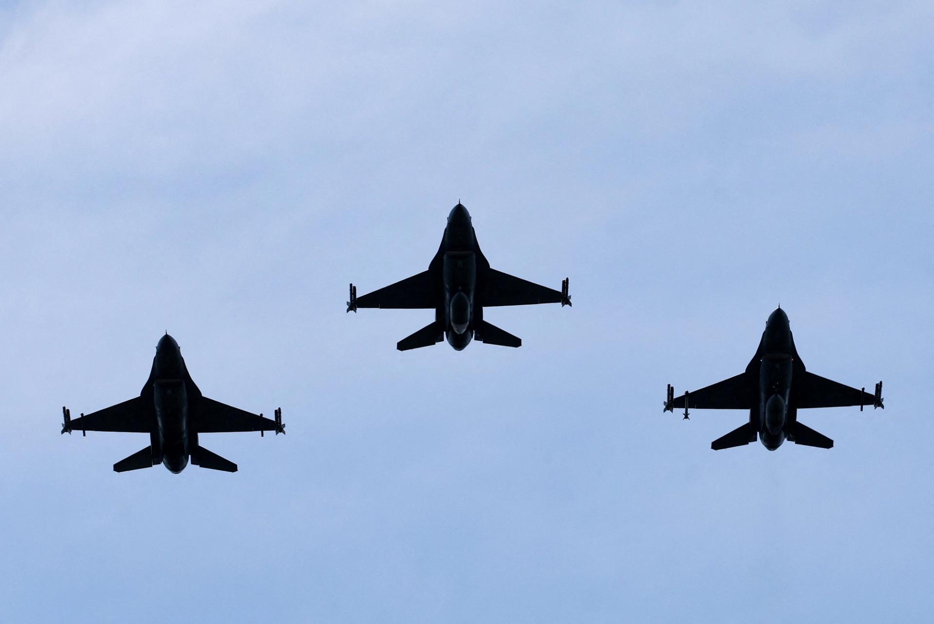 Belgian F-16 jets fly during a ceremony. 