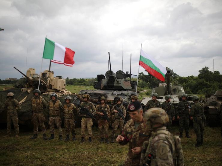 Bulgarian, U.S. and Italian soldiers stand in front of armoured vehicles and tanks during “Defensive Shield - 2023” military exercises at Novo Selo military grounds, Bulgaria, May 29, 2023.