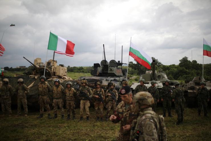 Bulgarian, U.S. and Italian soldiers stand in front of armoured vehicles and tanks during “Defensive Shield - 2023” military exercises at Novo Selo military grounds, Bulgaria, May 29, 2023.