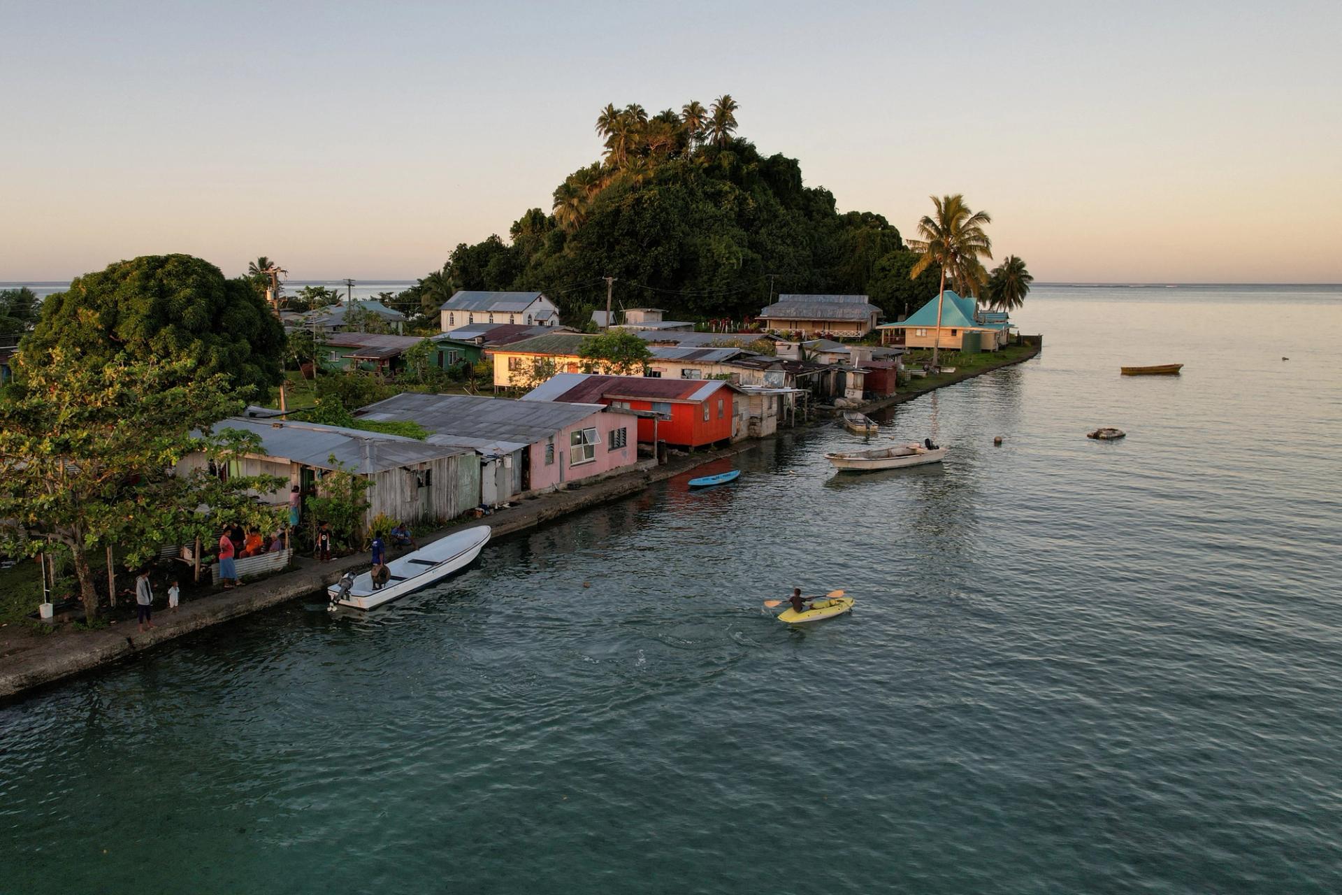 FILE PHOTO: The morning’s first rays of sunlight hit the island community of Serua Village, Fiji, July 15, 2022. As the community runs out of ways to adapt to the rising Pacific Ocean, the 80 villagers face the painful decision whether to move. REUTERS/Loren Elliott/File Photo