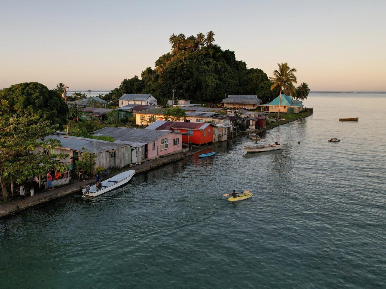 FILE PHOTO: The morning’s first rays of sunlight hit the island community of Serua Village, Fiji, July 15, 2022. As the community runs out of ways to adapt to the rising Pacific Ocean, the 80 villagers face the painful decision whether to move. REUTERS/Loren Elliott/File Photo