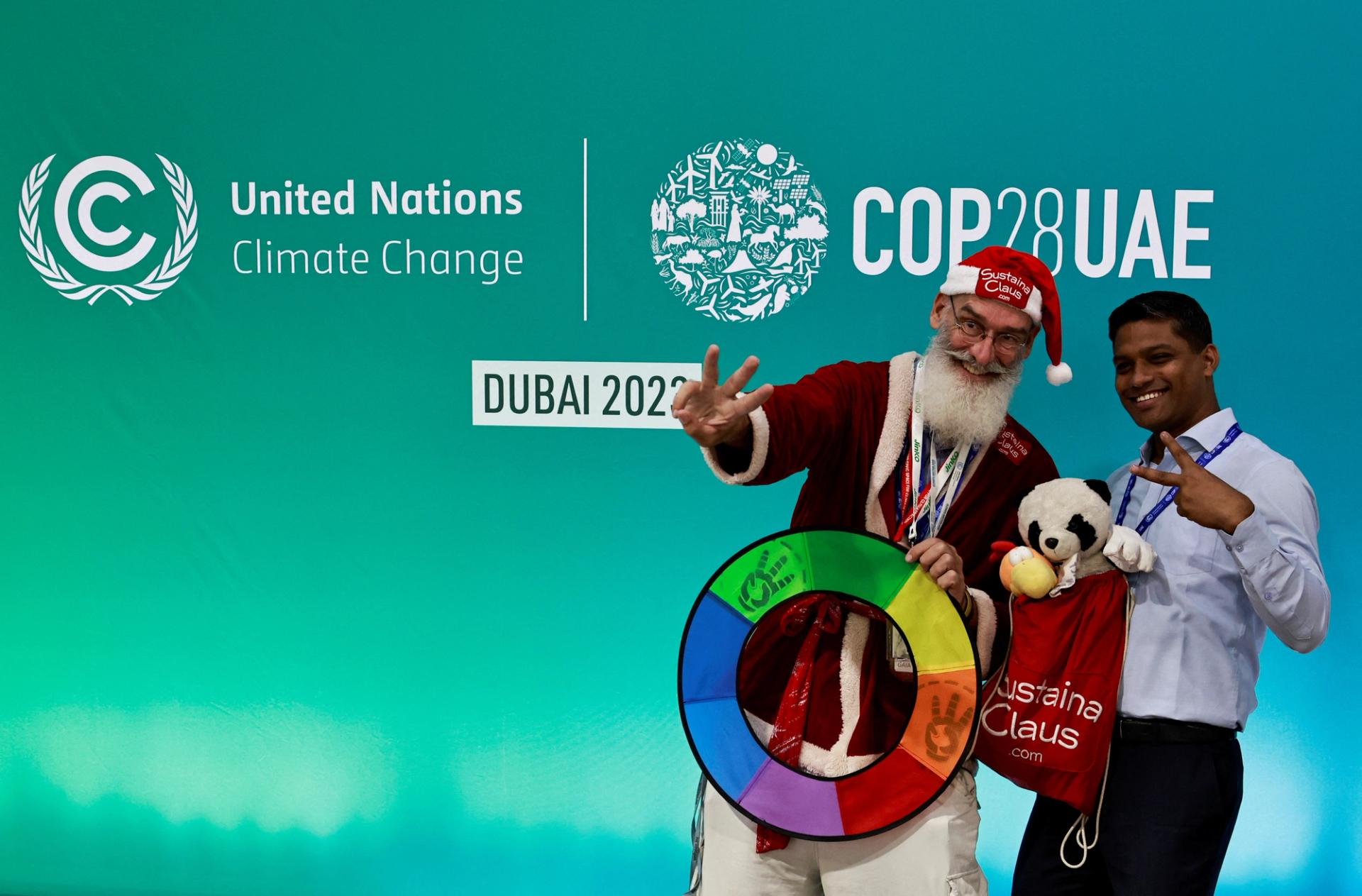 An observer dressed as Santa Claus gestures as he poses for a photo, at the United Nations Climate Change Conference COP28 in Dubai, United Arab Emirates, December 11, 2023.