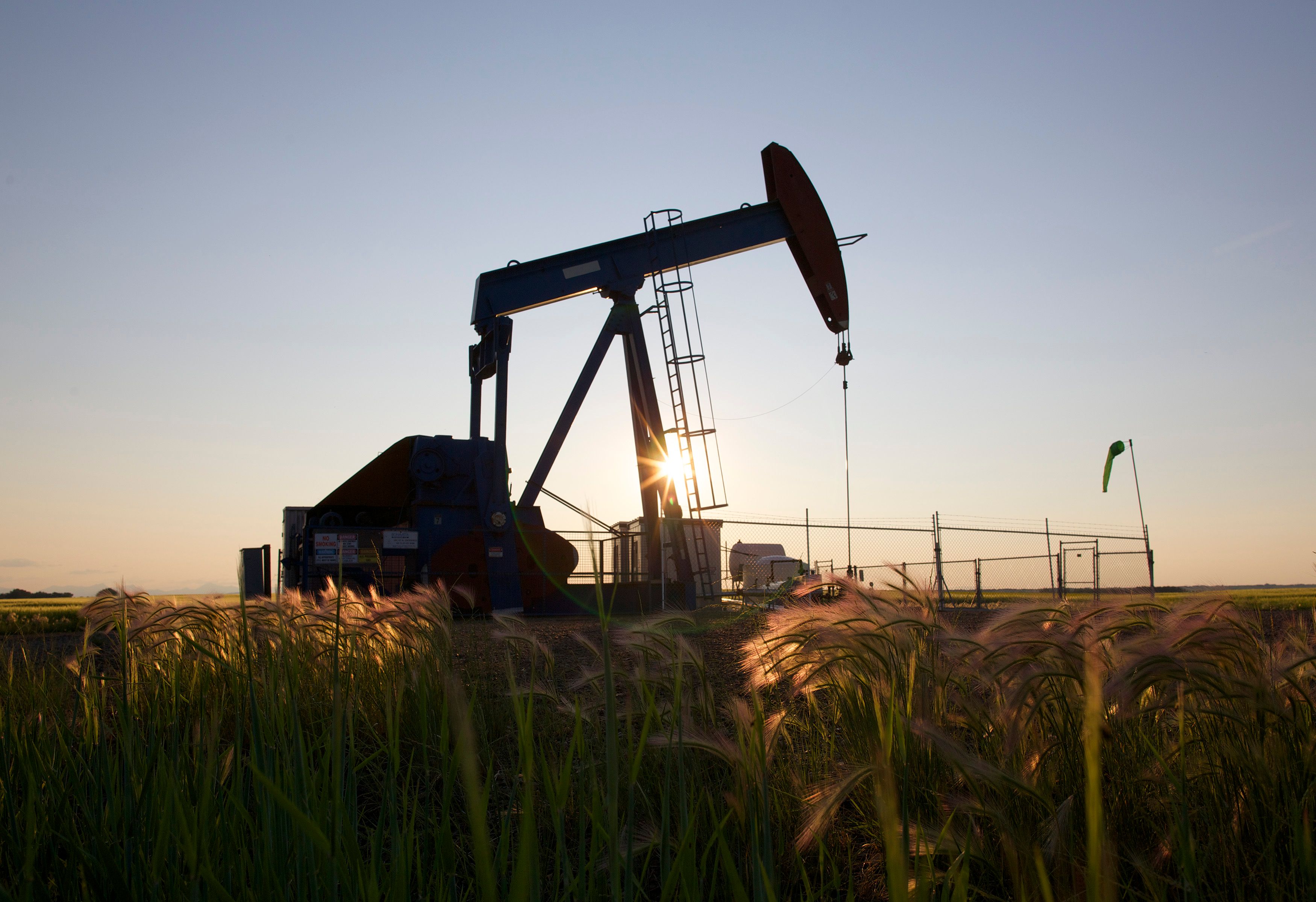 An oil pump jack pumps oil in a field near Calgary, Alberta, Canada.
