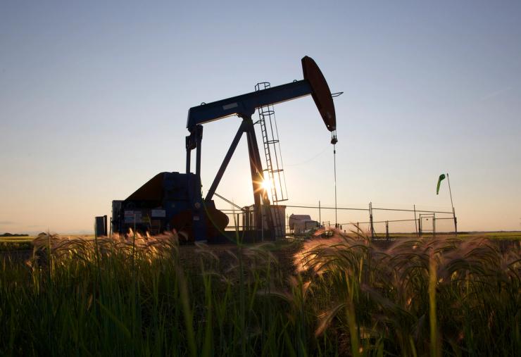 An oil pump jack pumps oil in a field near Calgary, Alberta, Canada.