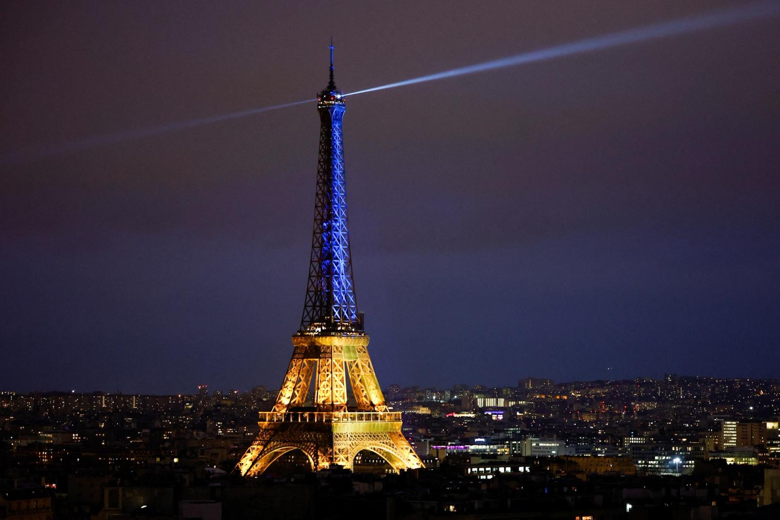 The Eiffel Tower is lit up in the national blue-and-yellow colours of Ukraine, to mark the first anniversary of Russia's invasion of Ukraine, in Paris, France, February 23, 2023. REUTERS/Sarah Meyssonnier