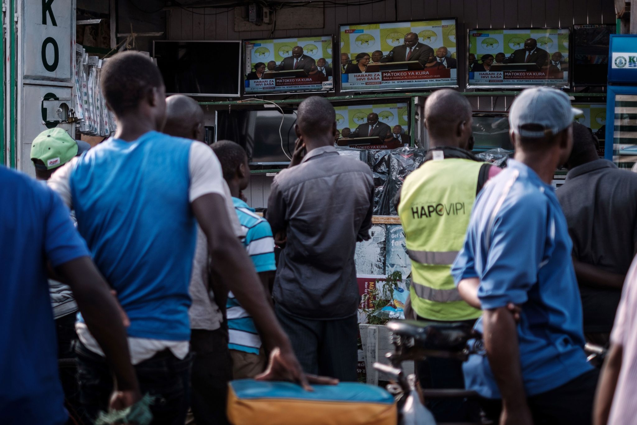 People watch a live broadcast in Kisumu, Kenya.