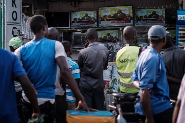 People watch a live broadcast in Kisumu, Kenya.