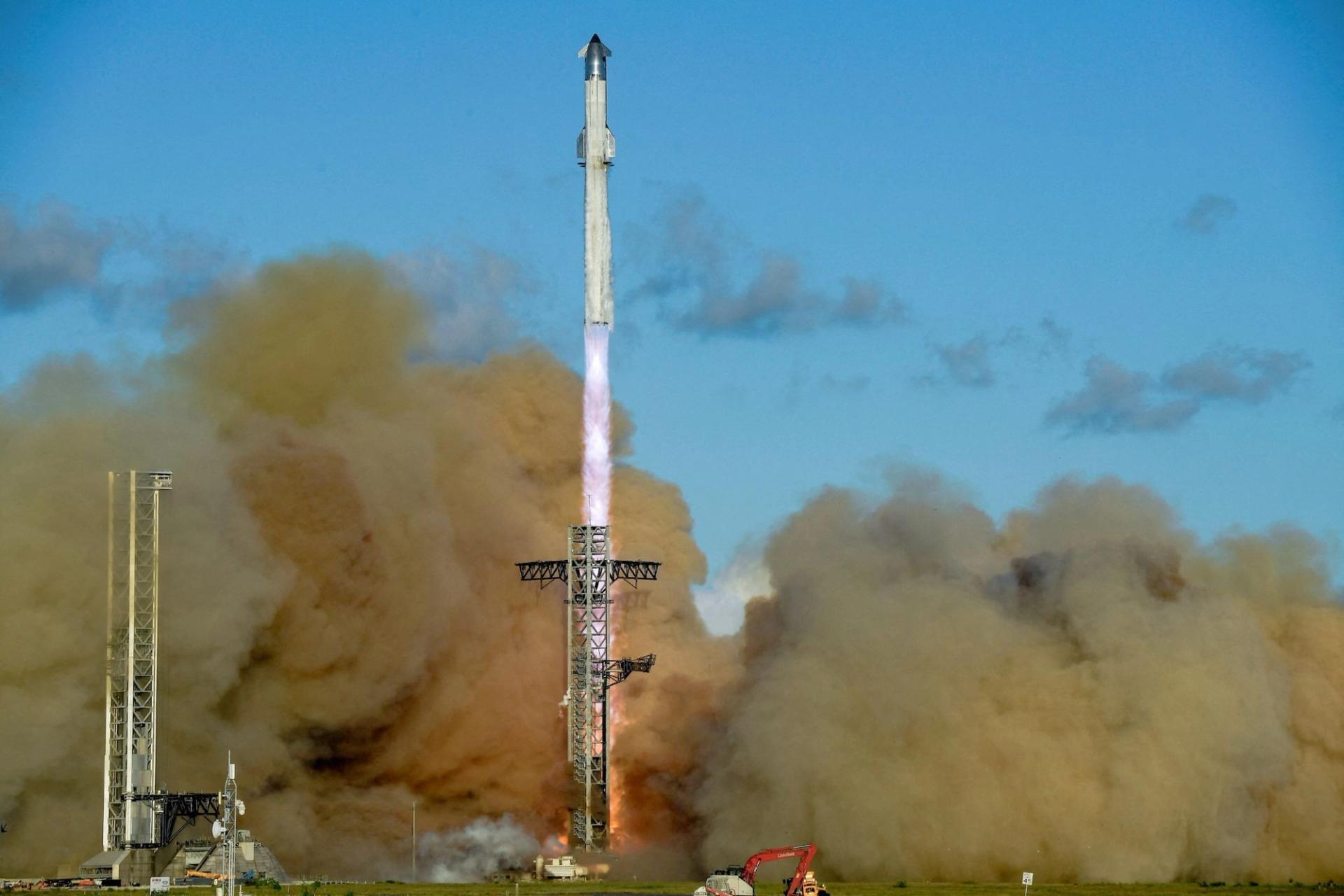 A SpaceX Super Heavy booster carrying the Starship spacecraft lifts off in Texas. 