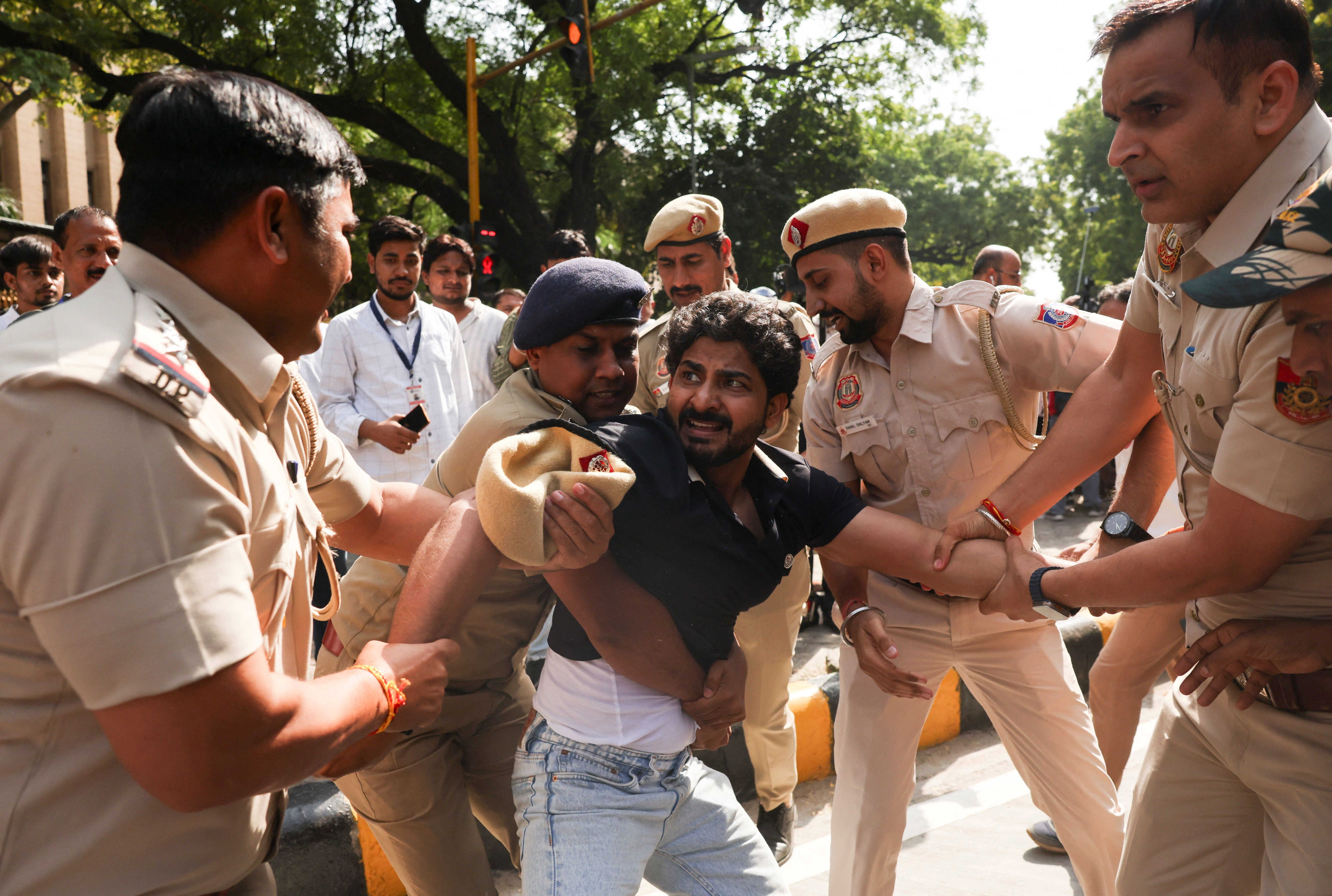 A demonstrator is being detained during a protest organised by opposition parties demanding the resignation of Chief Election Commissioner Gyanesh Kumar in New Delhi, India, Oct. 6, 2026.