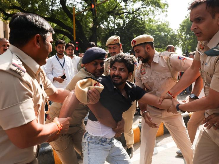 A demonstrator is being detained during a protest organised by opposition parties demanding the resignation of Chief Election Commissioner Gyanesh Kumar in New Delhi, India, Oct. 6, 2026.