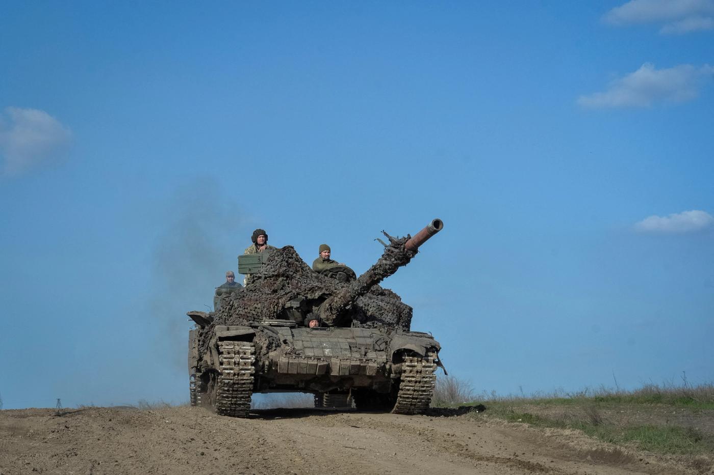 Ukrainian service members ride a tank near the front line city of Bakhmut.