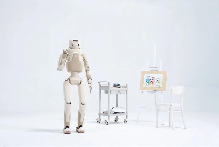 A humanoid robot standing next to a painting.