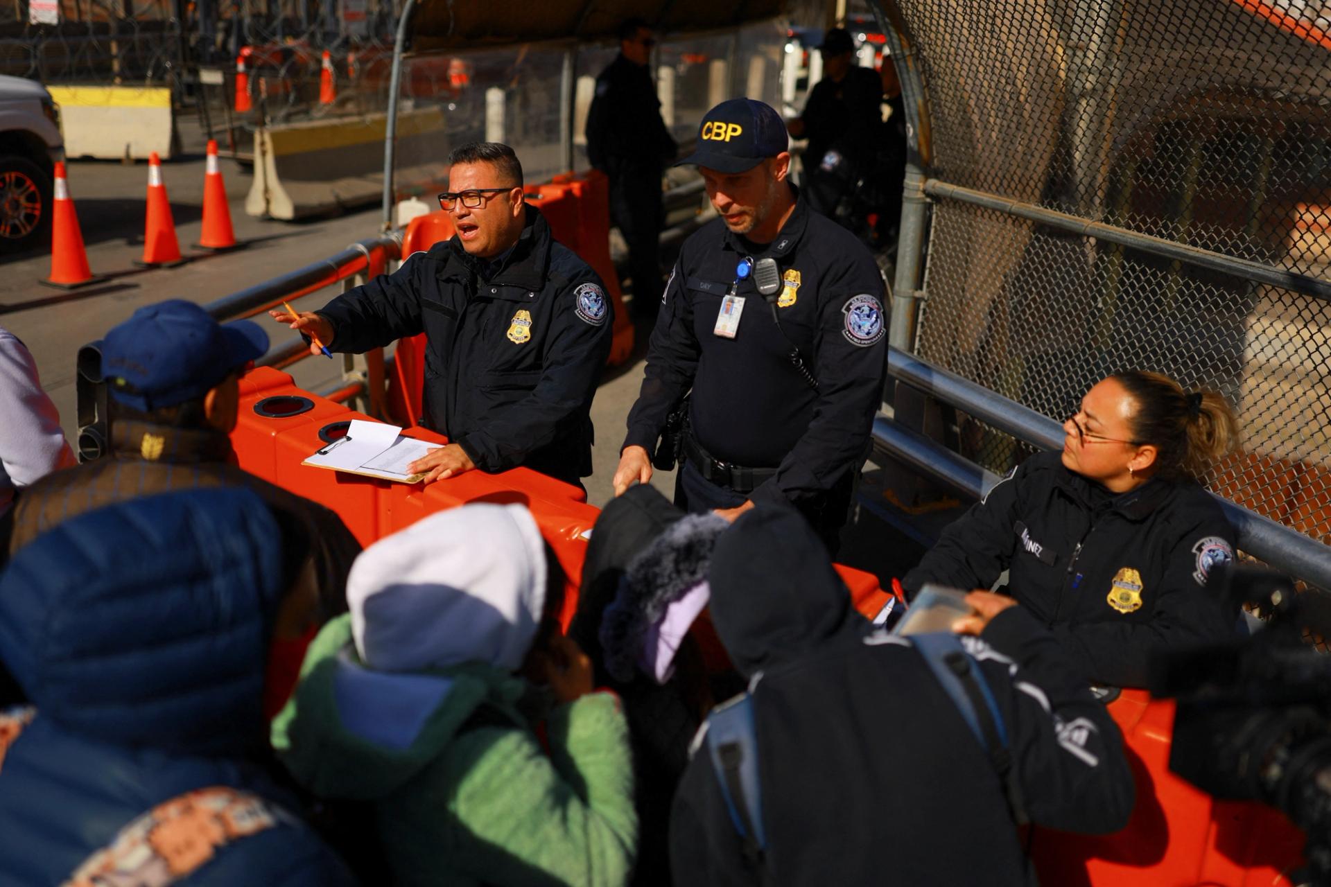 US Customs and Border Protection agents work as migrants who requested an appointment in the US using the CBP One application wait to be received in Ciudad Juarez, Mexico.