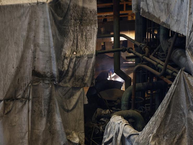 An employee works at a thermal power plant damaged during Russian missile strikes in Ukraine.