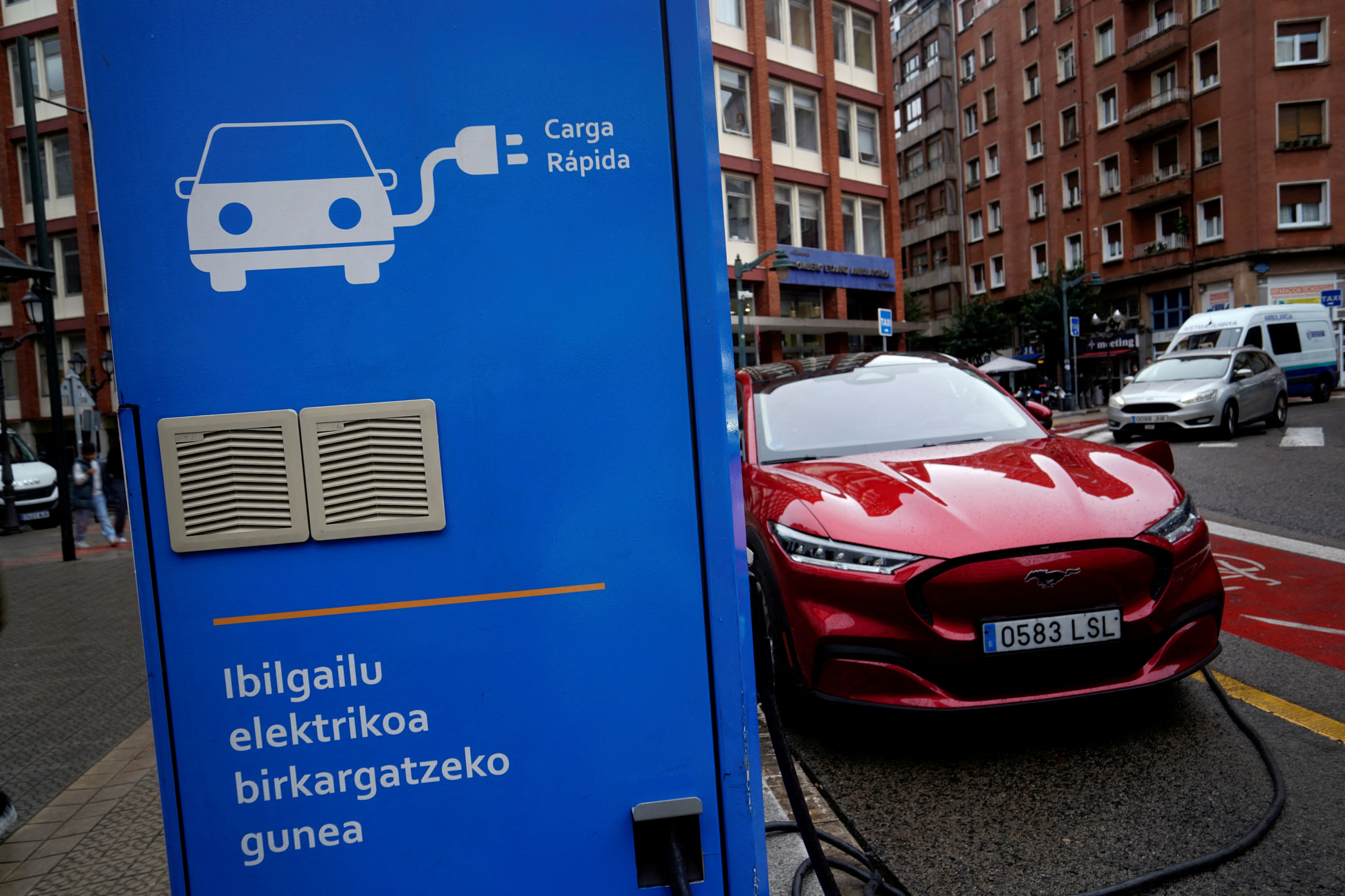 A Ford Mustang Mach-e electric vehicle is seen plugged into a charging station in Bilbao.
