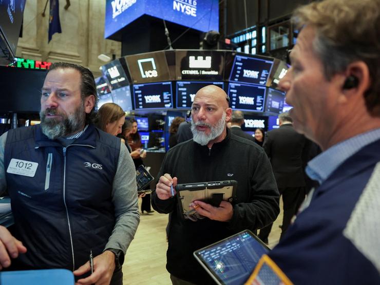 Traders work on the floor during the York Space Systems IPO at the New York Stock Exchange.