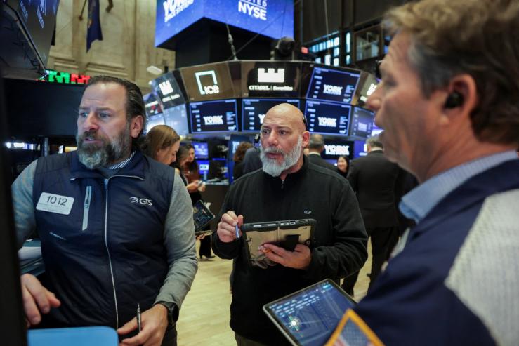 Traders work on the floor during the York Space Systems IPO at the New York Stock Exchange.