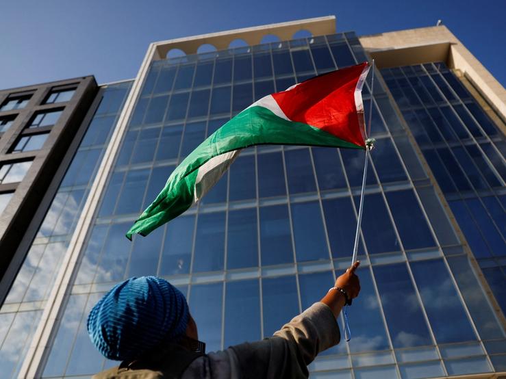 A protester waves a Palestinian flag outside AIPAC offices in Washington.