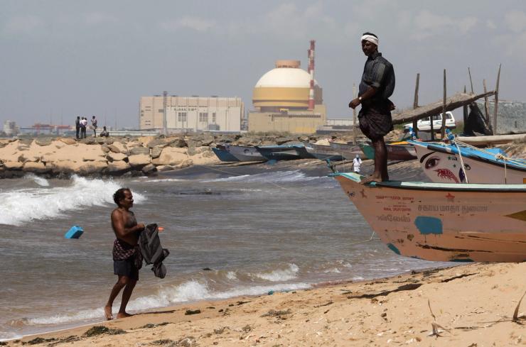 A fisherman stands on his boat on a beach near Kudankulam nuclear power project in the southern Indian state of Tamil Nadu