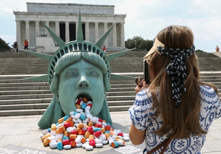 Pills spill out of the mouth a Lady Liberty installation at the Lincoln Memorial