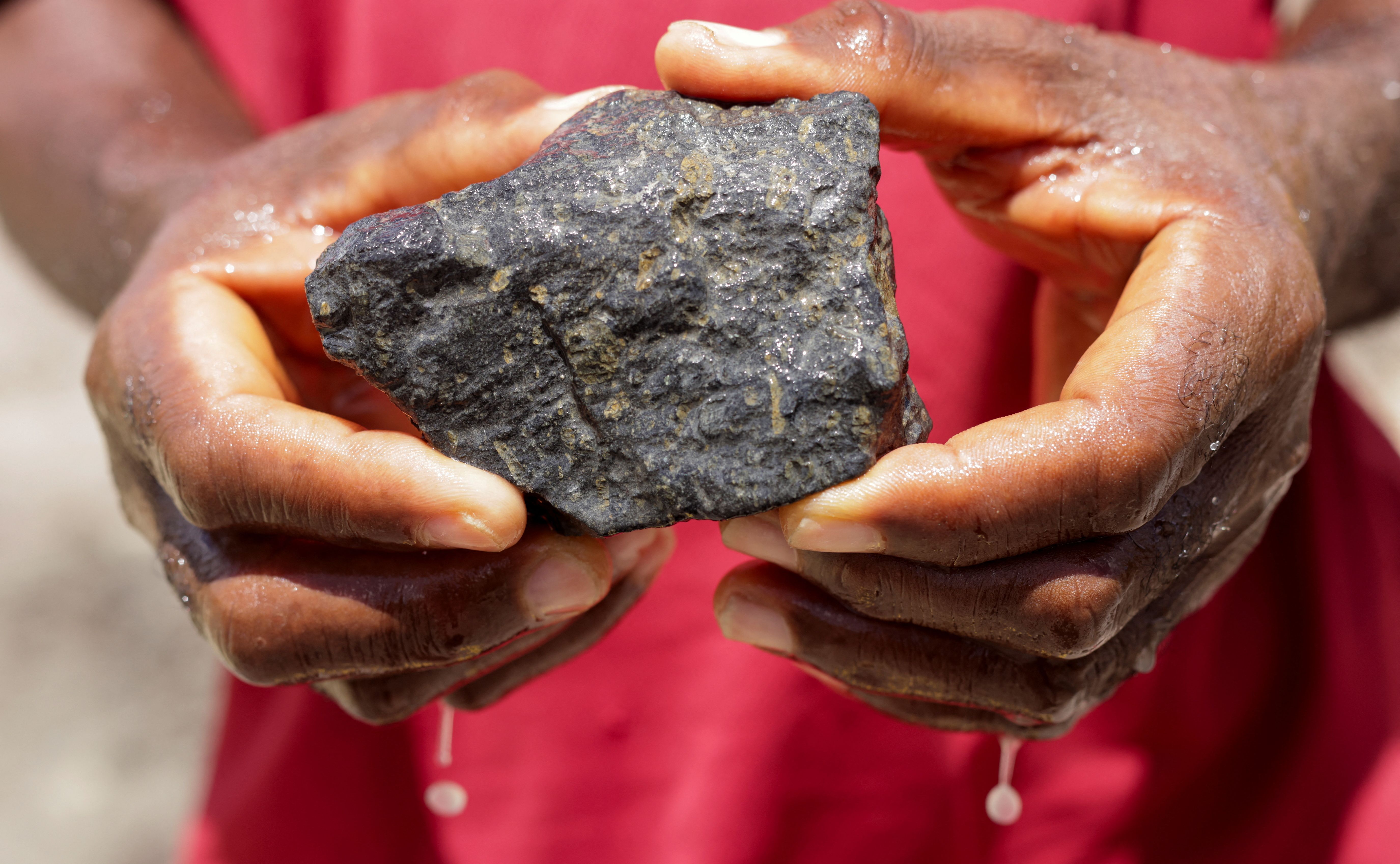 Tamba Fomba, an artisanal miner, holds a piece of Kimberlite rock, the source of Sierra Leone’s diamonds, in Sierra Leone, West Africa, Oct. 6, 2025