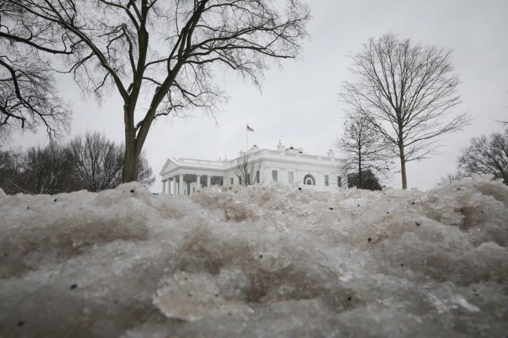 Ice from a previous day snow storm is seen along the White House North Lawn in 2021.