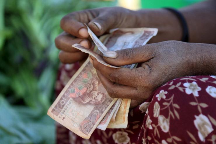 A woman counts Ethiopian birr notes.