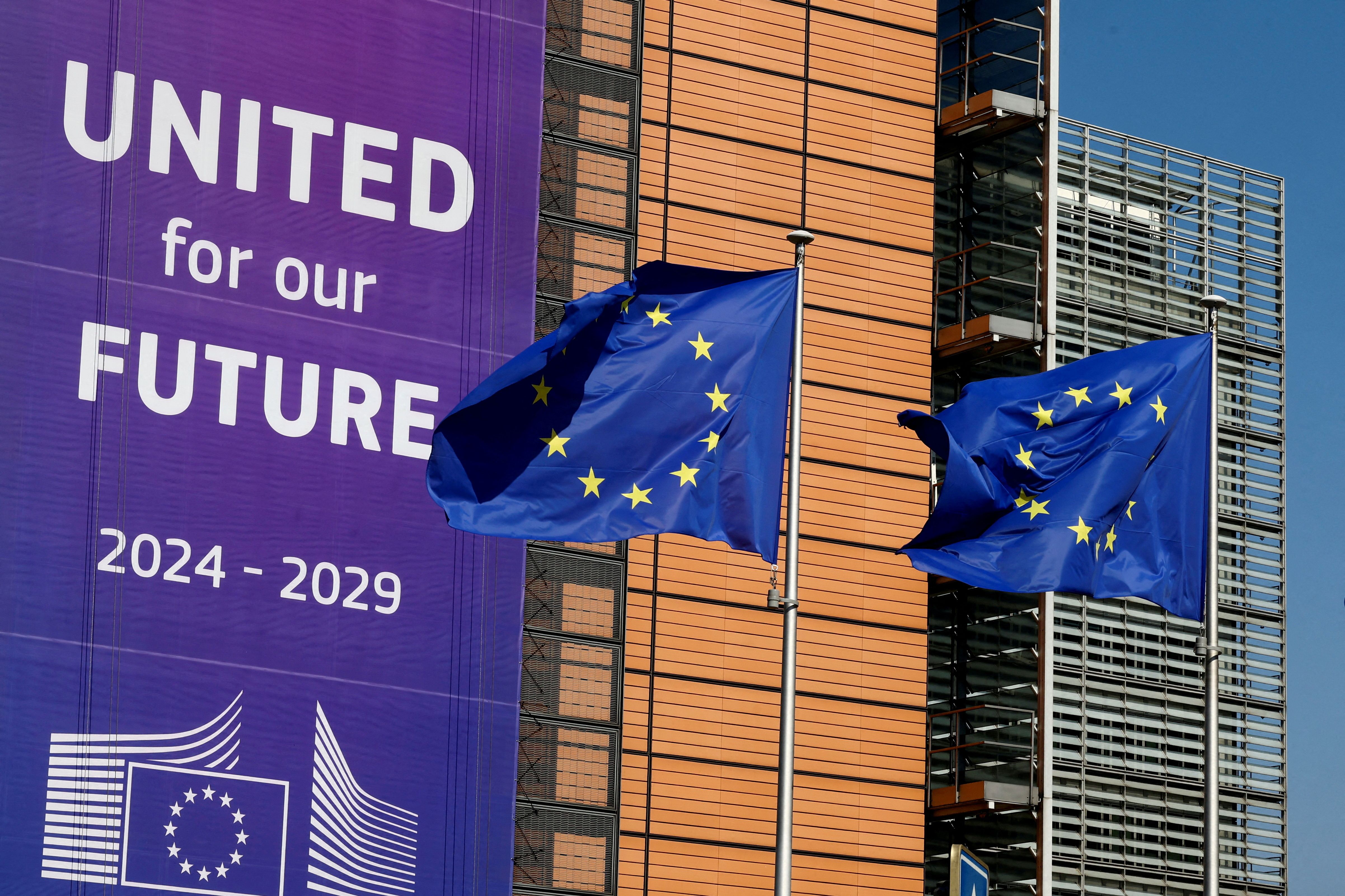 European Union flags flutter outside the European Commission headquarters in Brussels