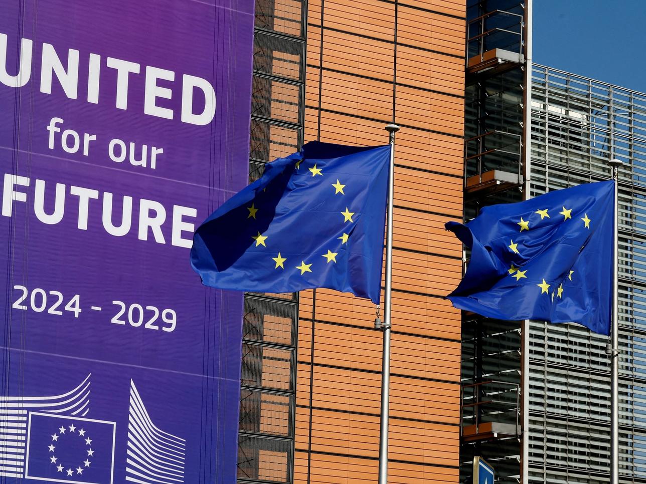 European Union flags flutter outside the European Commission headquarters in Brussels