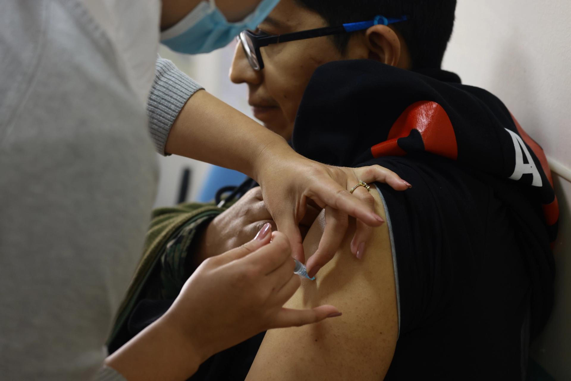 A health worker administers a dose of Stamaril vaccine amid a whooping cough and yellow fever outbreak on May 6, 2025 in Quito, Ecuador.