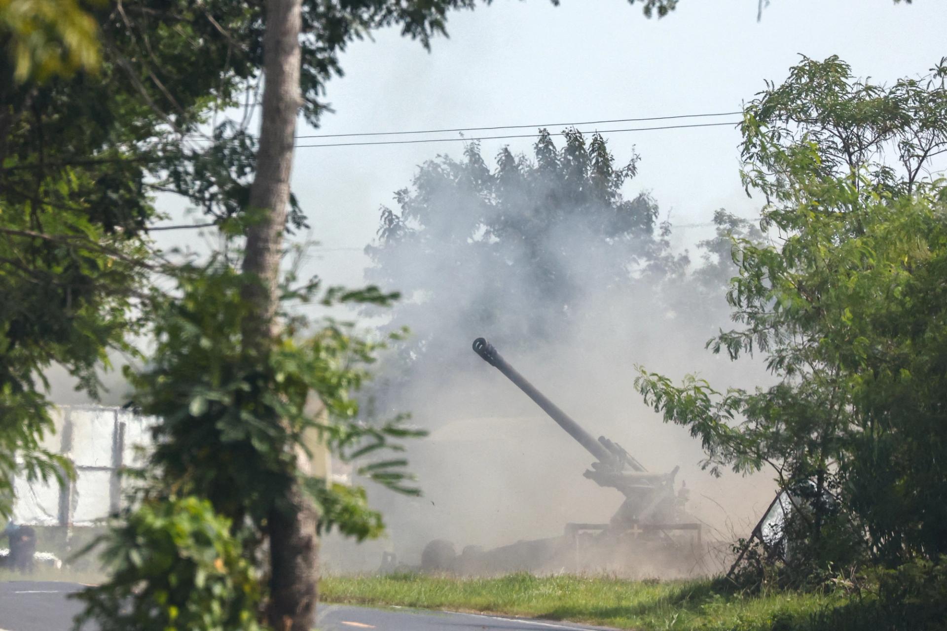A Thai military mobile unit fires towards Cambodia’s side after Thailand and Cambodia