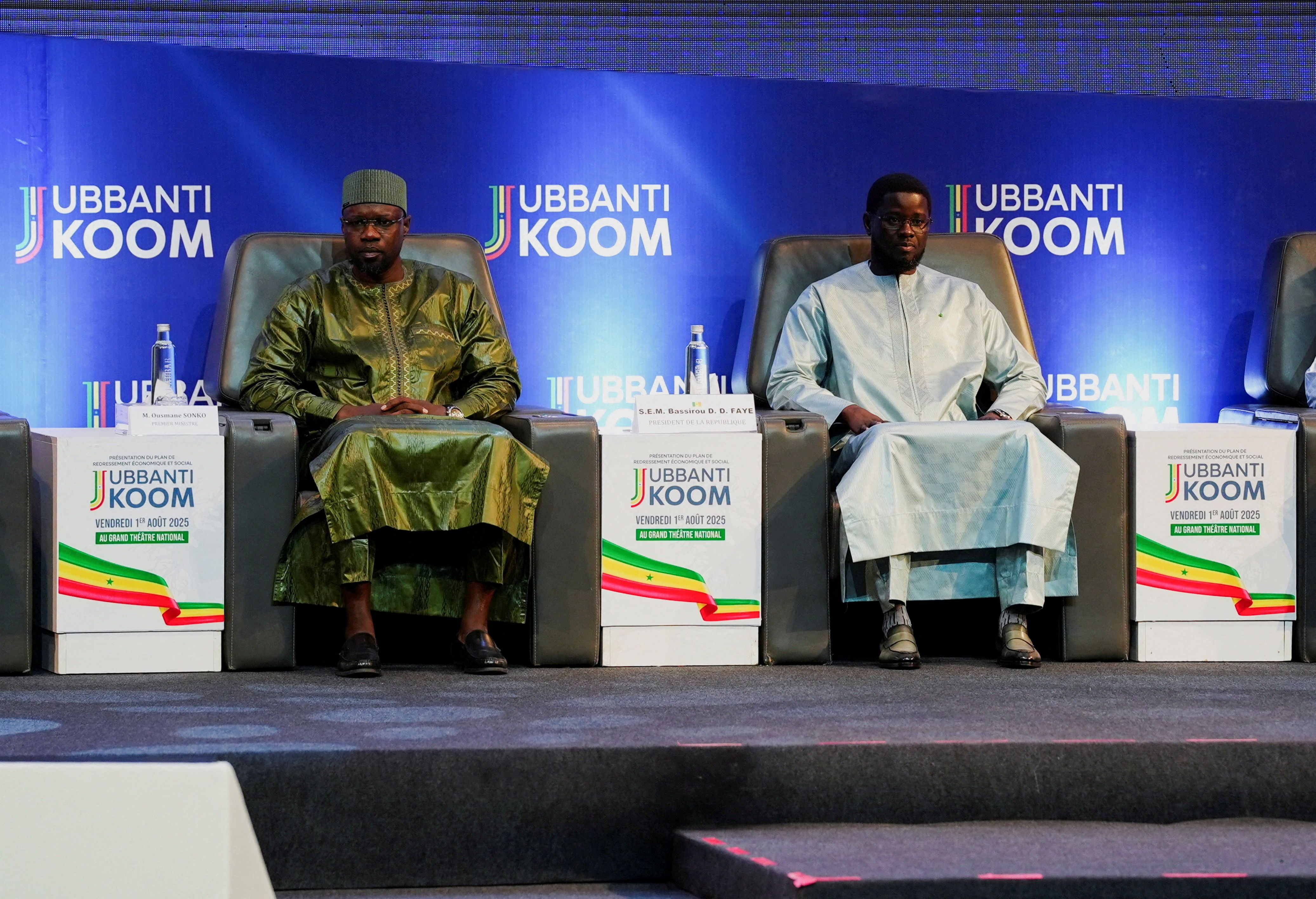 Senegal’s fomer Prime Minister Ousmane Sonko sits with Senegal’s President Bassirou Diomaye Faye.