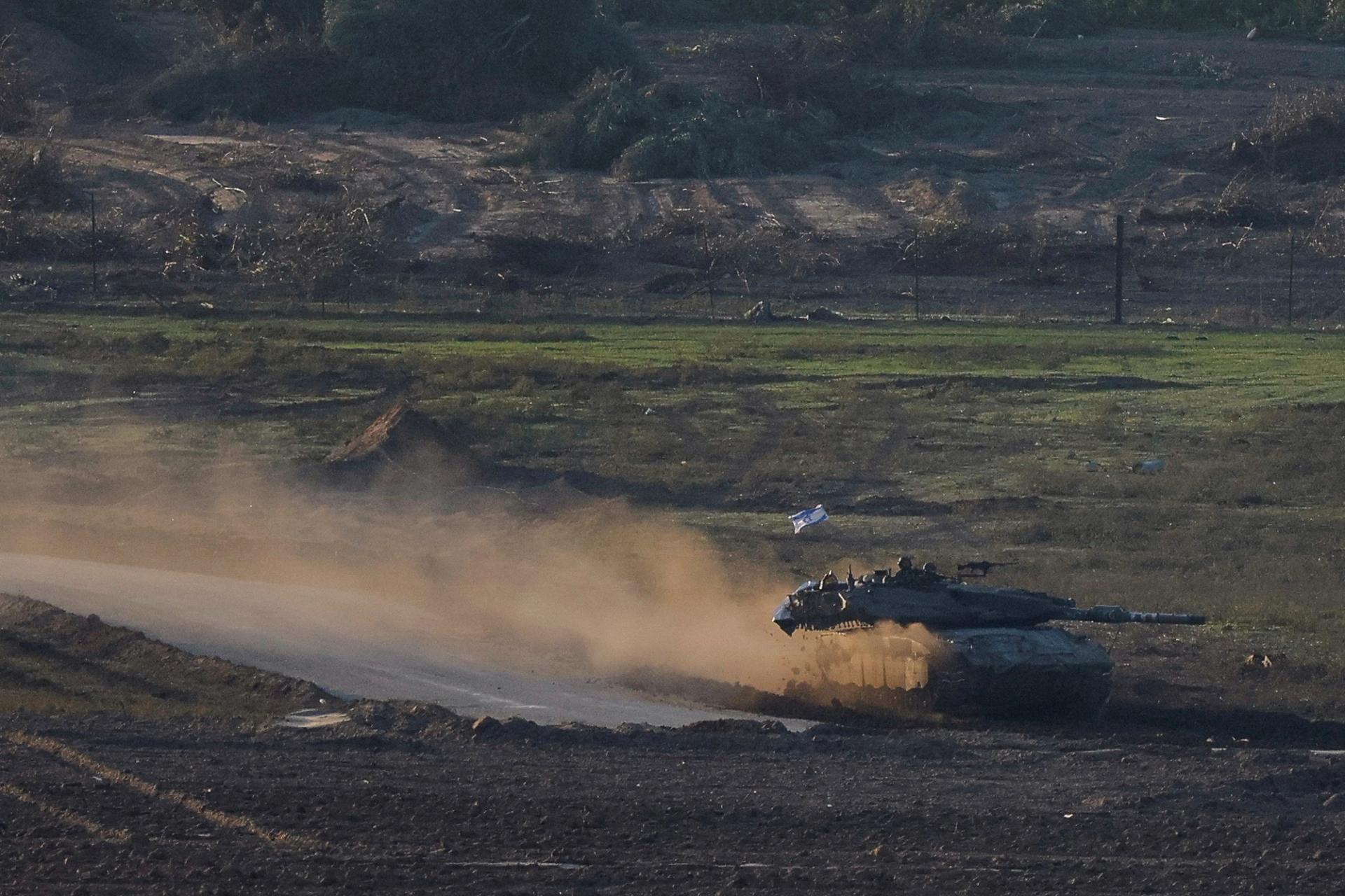 An Israeli tank maneuvers in Gaza, near the Israel-Gaza border, amid the ongoing conflict between Israel and the Palestinian Islamist group Hamas, as seen from southern Israel, December 2, 2023.