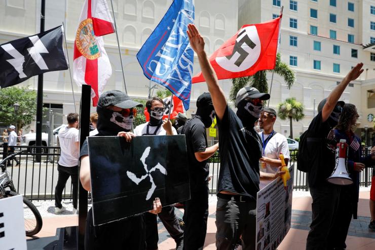 People posing with Nazi flags and signs
