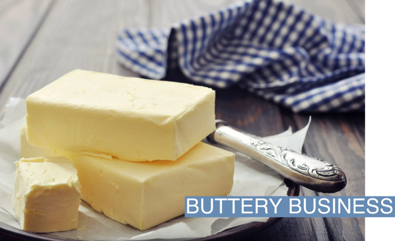 Two sticks of butter are shown served on a plate.