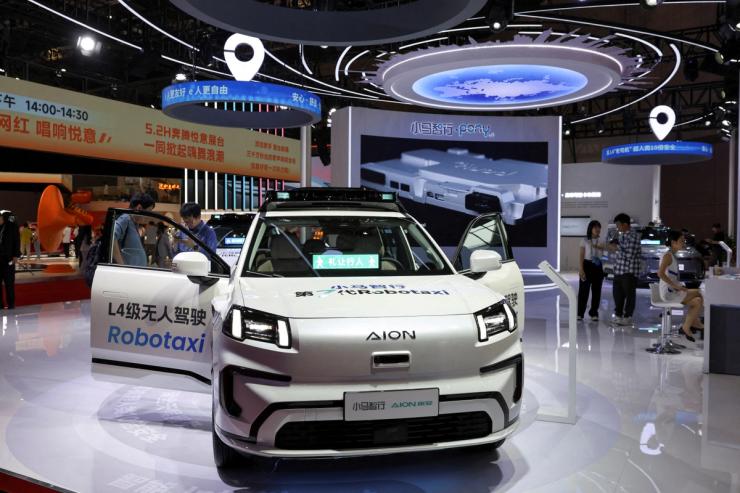 A Pony.ai Robotaxi is displayed at a booth.