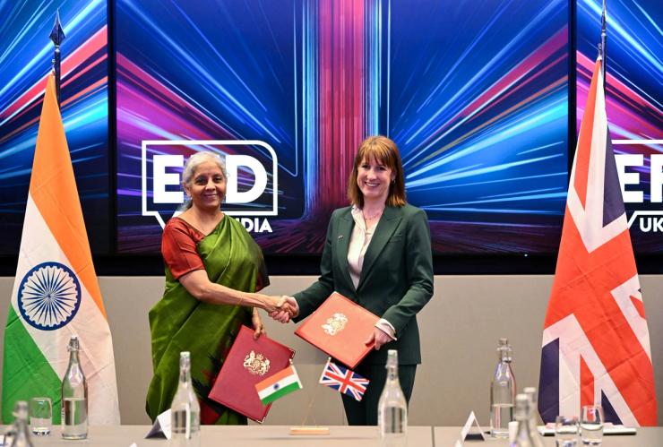 Britain’s Chancellor of the Exchequer Rachel Reeves (R) shakes hands with her Indian counterpart, Finance Minister Nirmala Sitharaman.