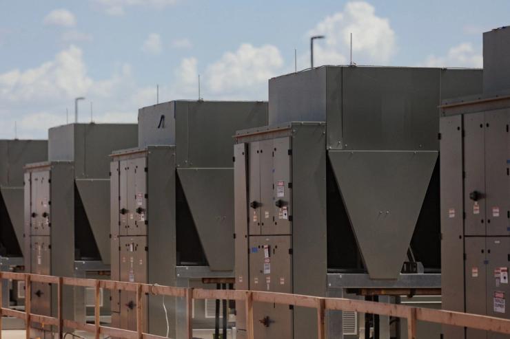 Chillers that cool water are connected to a data center building at the OpenAI data center in Abilene, Texas