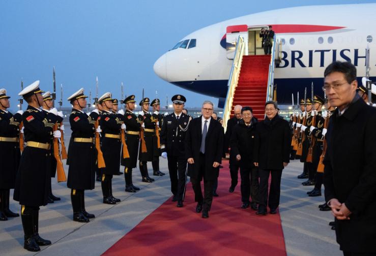 British Prime Minister Keir Starmer arrives, as British Ambassador to China Peter Wilson and Chinese Finance Minister Lan Foan walk alongside, in Beijing.
